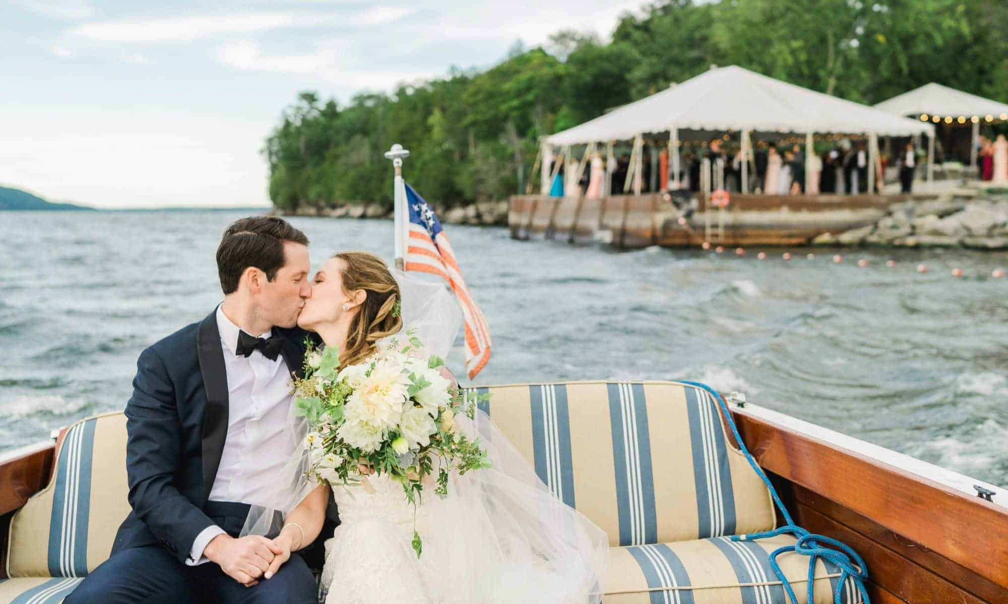 Basin Harbor Resort Wedding Photo Bride and Groom in Boat on Lake Champlain Kissing