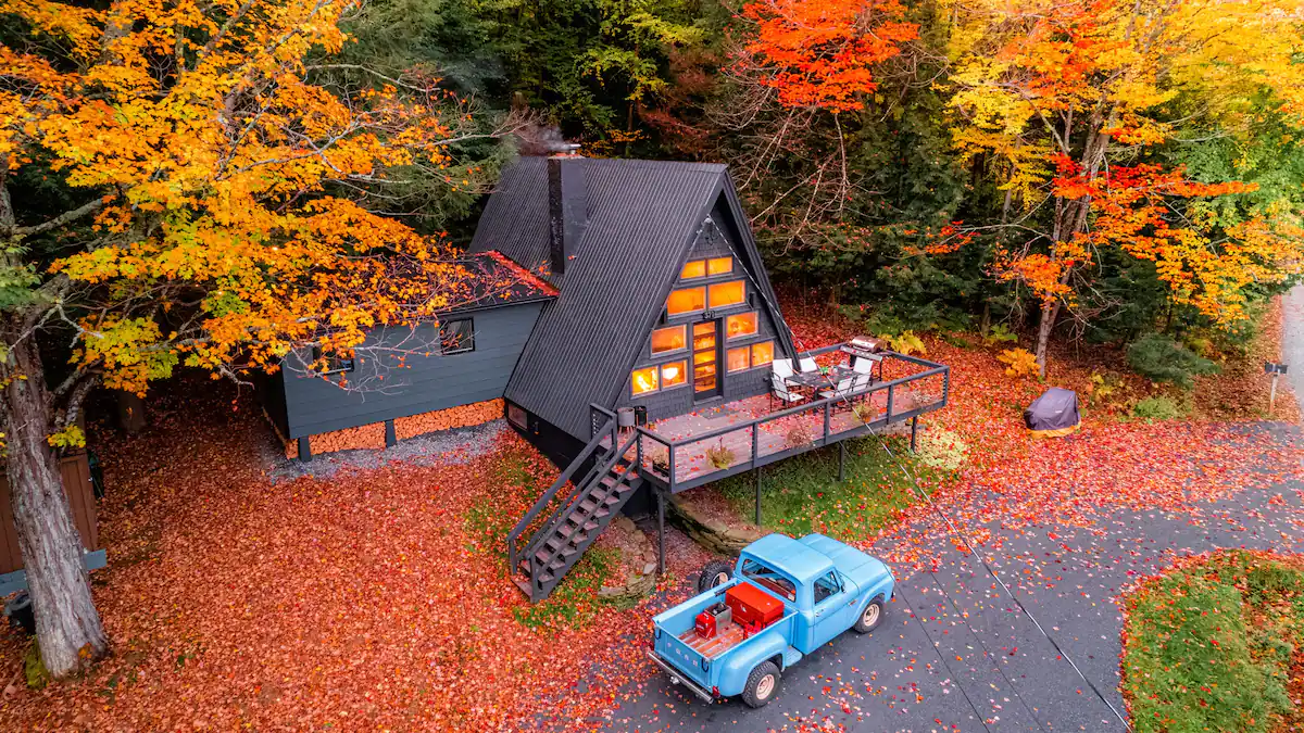 The Summit House Stowe Exterior Arial of A Frame Fall Foliage Blue Vintage Truck